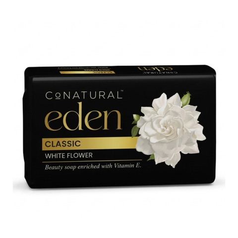 A rectangular bar of Con Natural Eden Classic White Flower soap in a black box with gold lettering and a white flower graphic, shown on a plain white background.