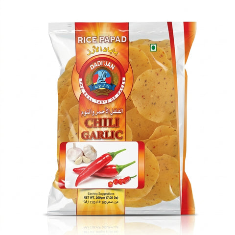 A bag of Dadi Jan Rice Papad in the Chilli Garlic flavor, featuring golden-brown garlic chips with visible red chili pepper flecks, packaged in a clear bag with a prominent orange and red label.