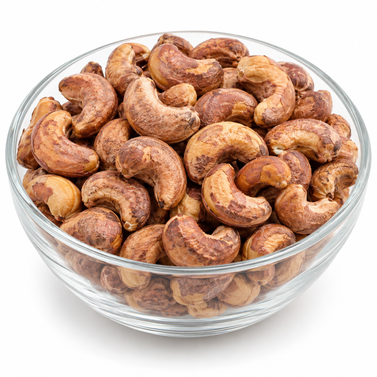 Skin-on roasted cashew nuts in a glass bowl